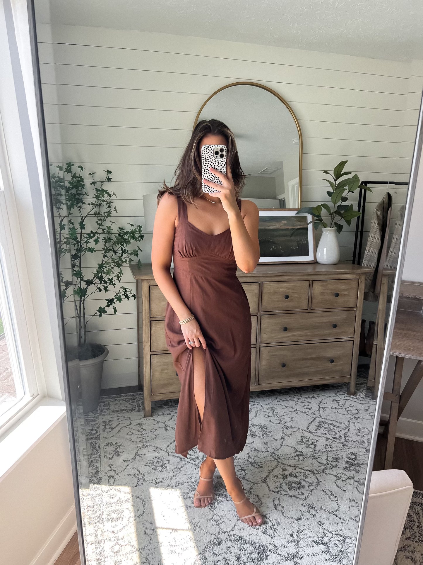 Woman takes a mirror selfie in the Brown V Neck Linen Midi Dress - DOORBUSTER, standing in a bright, stylish bedroom.