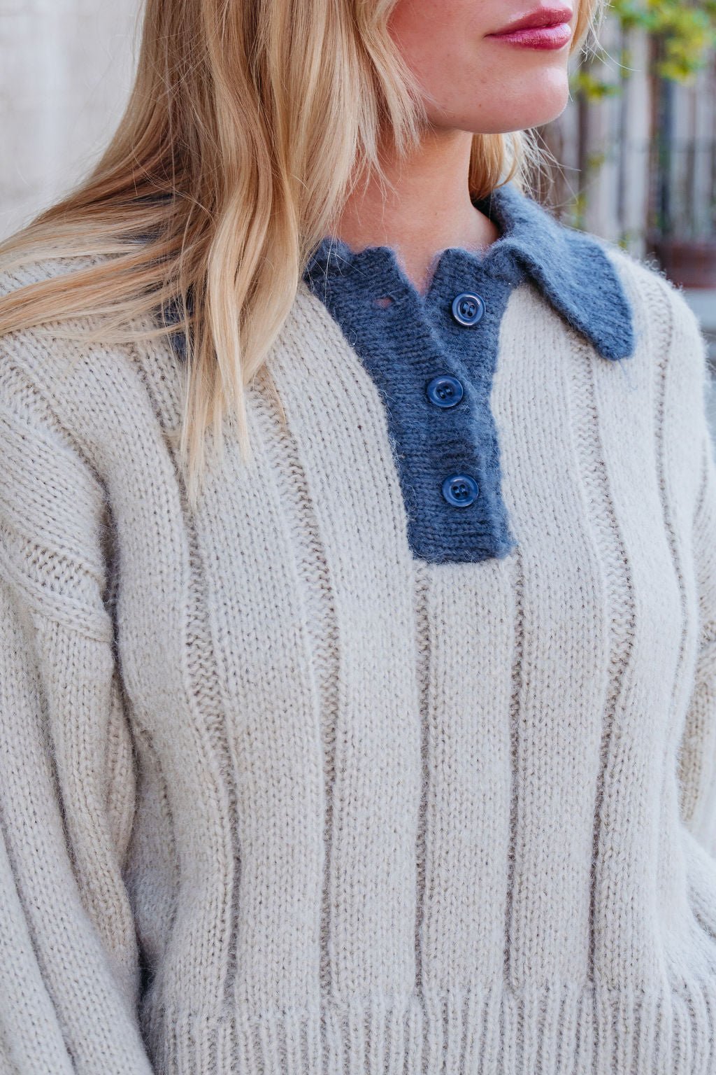 Woman wearing a Beige & Blue Button Up Sweater with collared V-neckline, ribbed knit, and blue buttons.