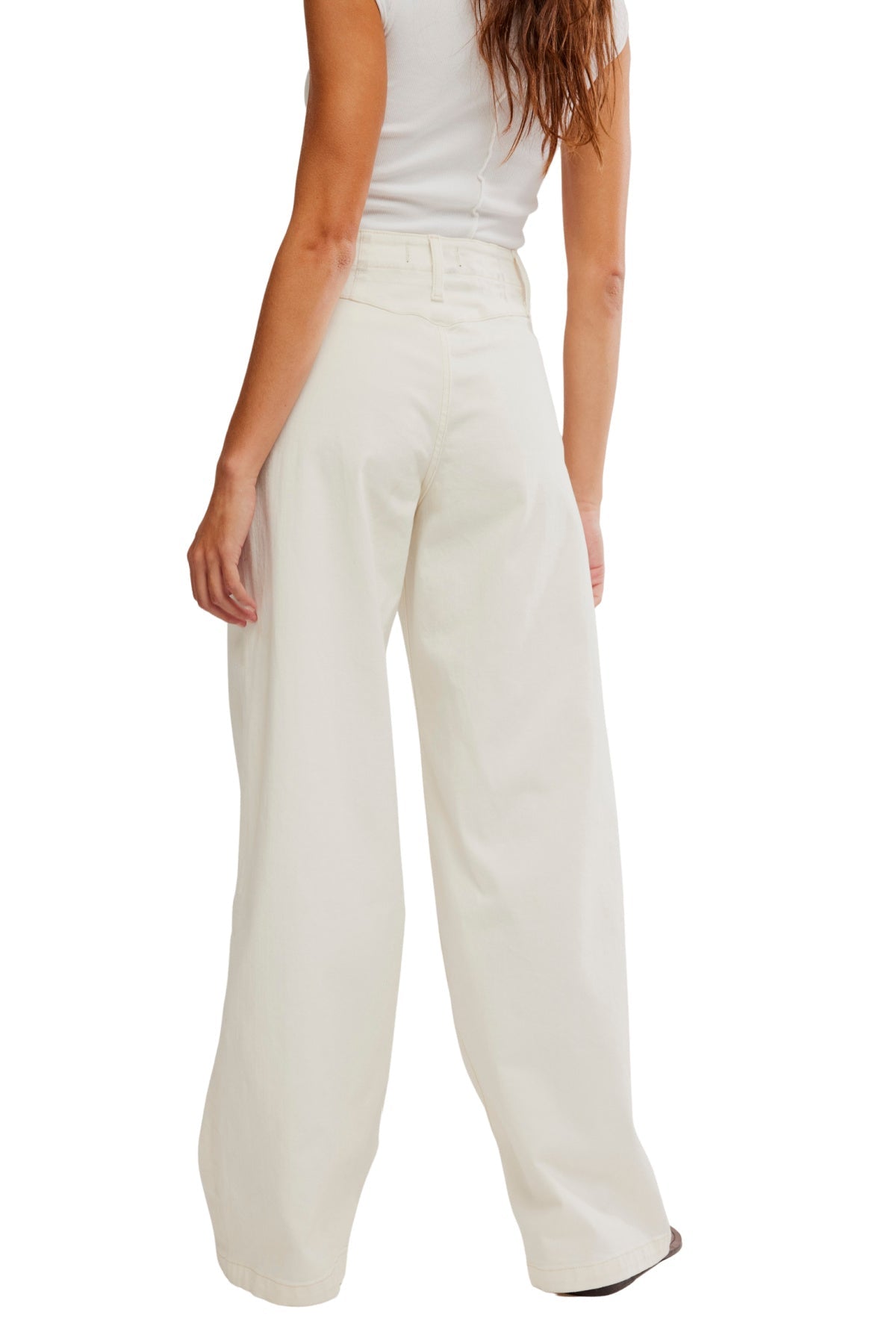 Woman wears Free People White Libre Wide Leg Jeans and a fitted white top, shown from the back on a white background.