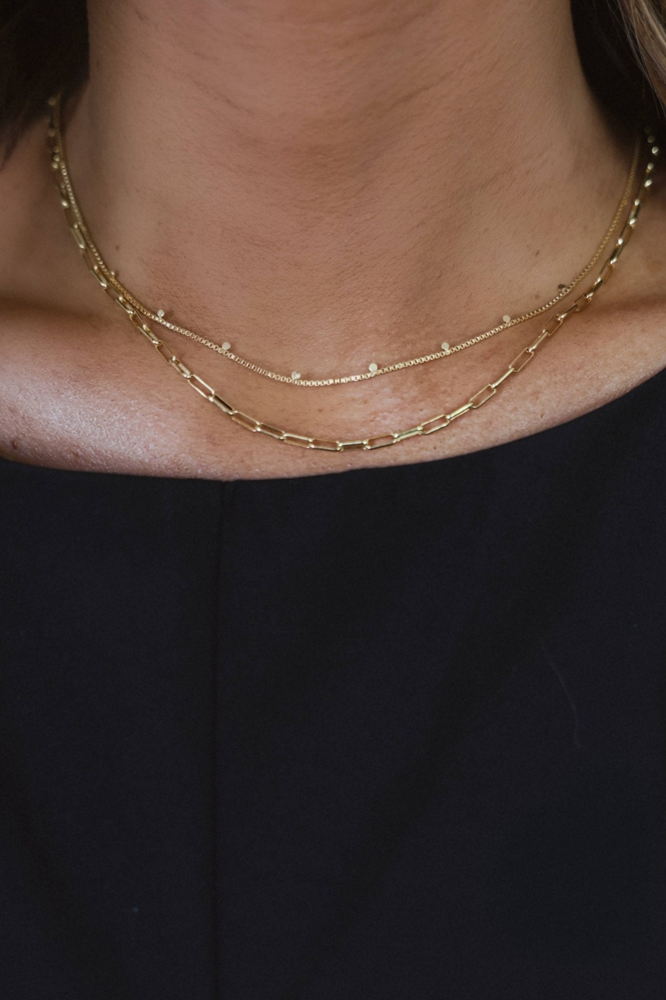 Close-up of a person wearing the Gold Dipped Mix Chain Necklace over a black top.