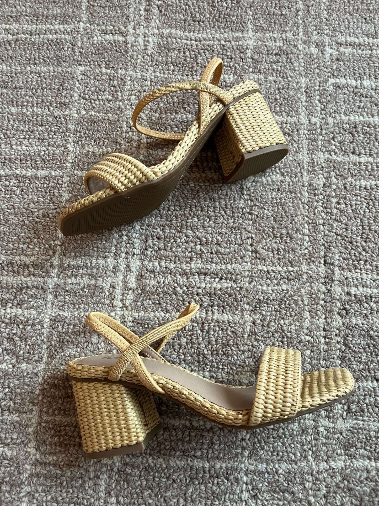 The MIA Zissy Natural Strappy Heels feature woven block heels and ankle straps on a light brown checkered carpet.