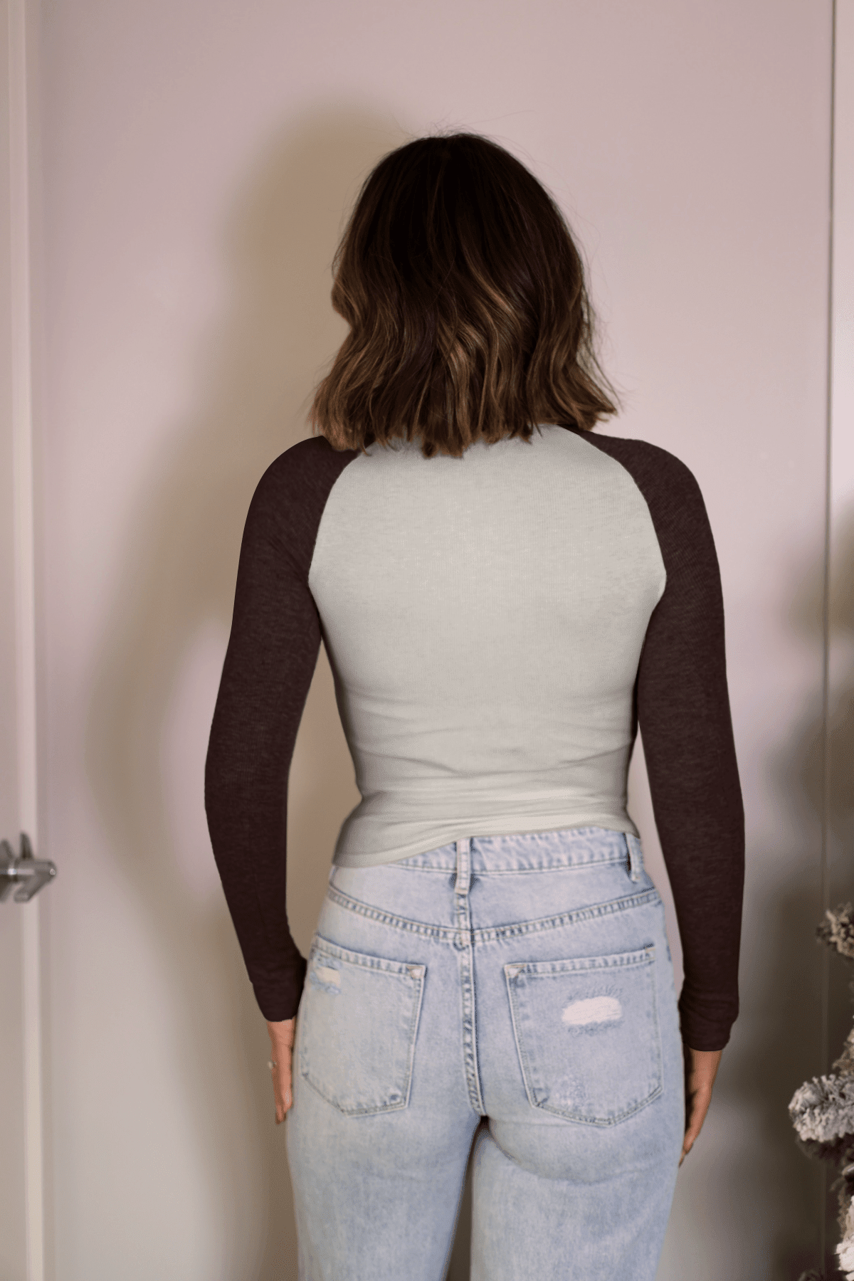 A person with shoulder-length brown hair wears the Natalie Brown Color Block Tee with light blue jeans, viewed from behind.