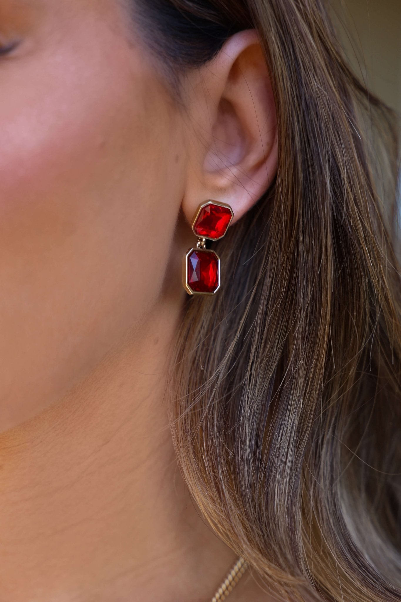 Red Double Gemstone Dangle Earrings with gold accents and two large rectangular red stones shown in close-up.