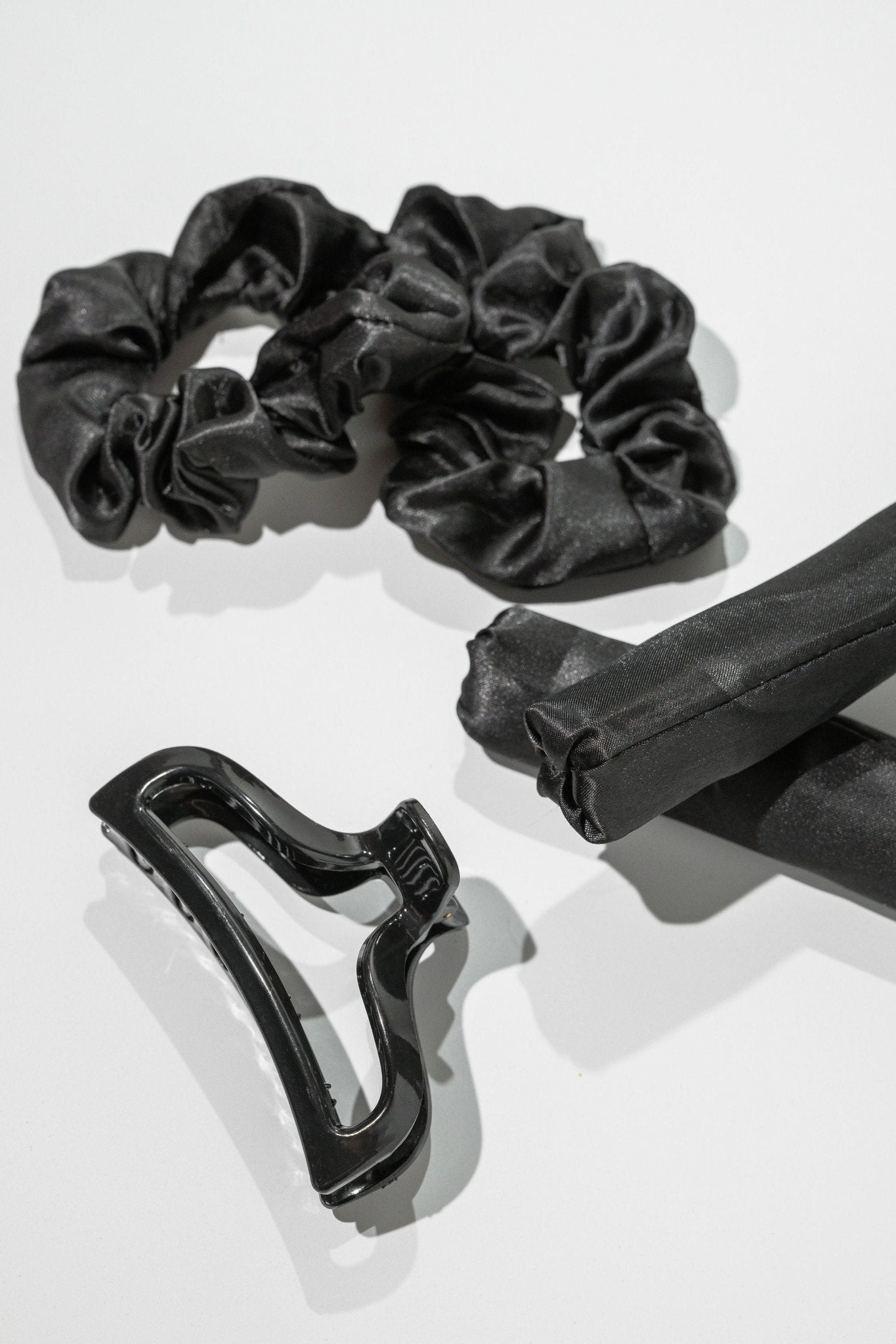 Satin Heatless Hair Curler Kit in Black, includes scrunchies and hair clip, displayed on a white surface.