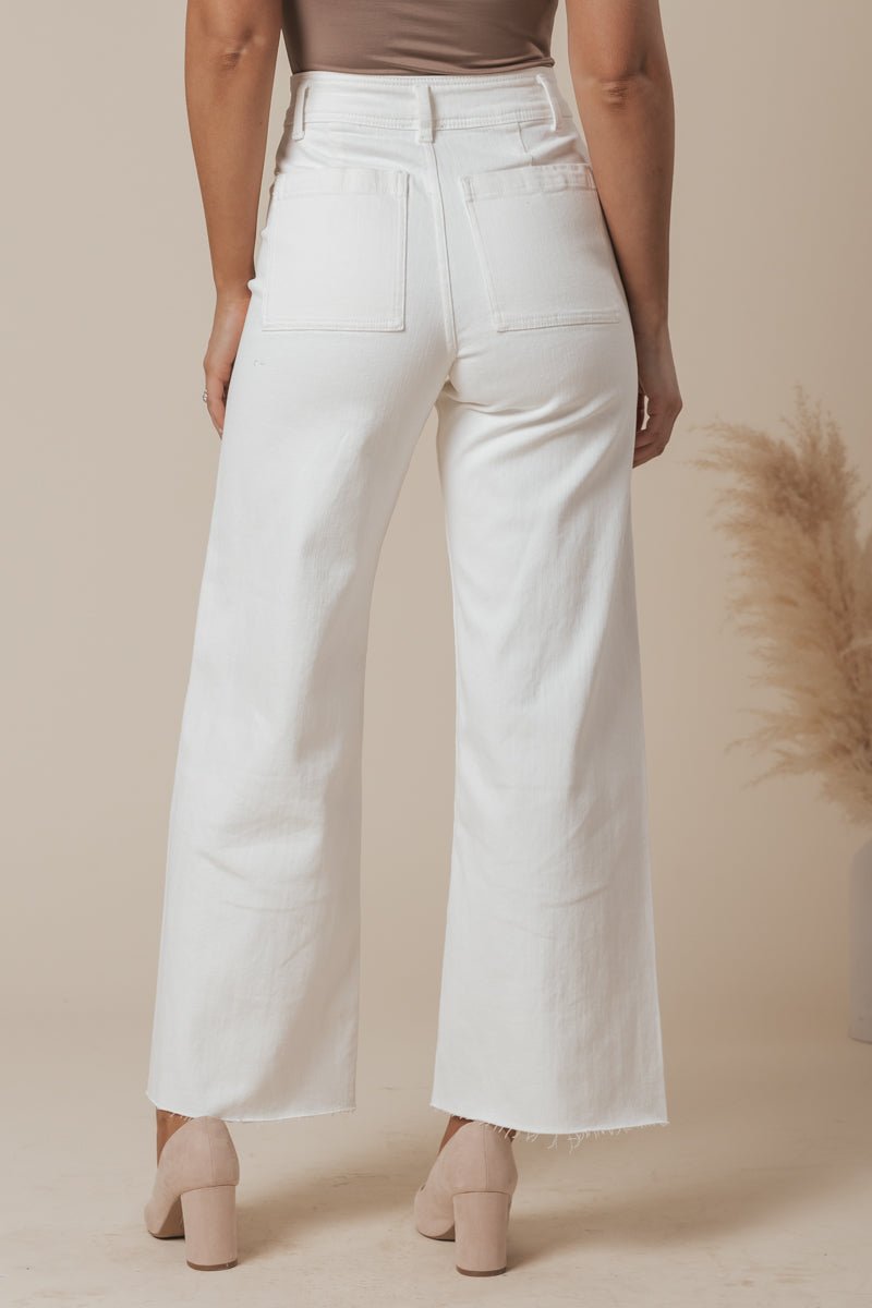 Woman wearing White Straight Wide Leg Pants - FINAL SALE with beige heels, shown from the back against a neutral background.