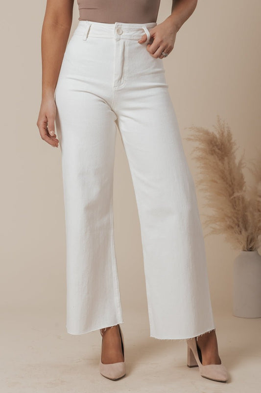 Woman in White Straight Wide Leg Pants and beige heels, posing with hand on hip—ideal for a casual, neutral-toned setting.