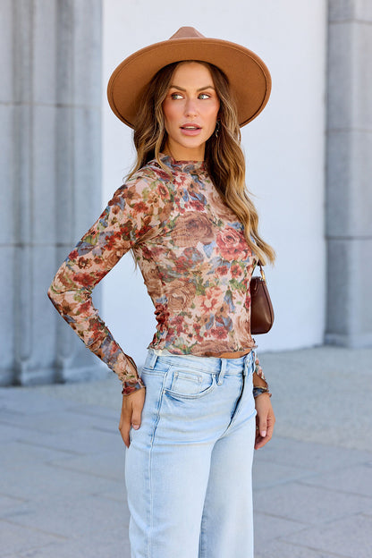 Woman wears the Elevated Floral Mesh Top - Cream with light jeans and a tan hat, standing outdoors and looking to the side.