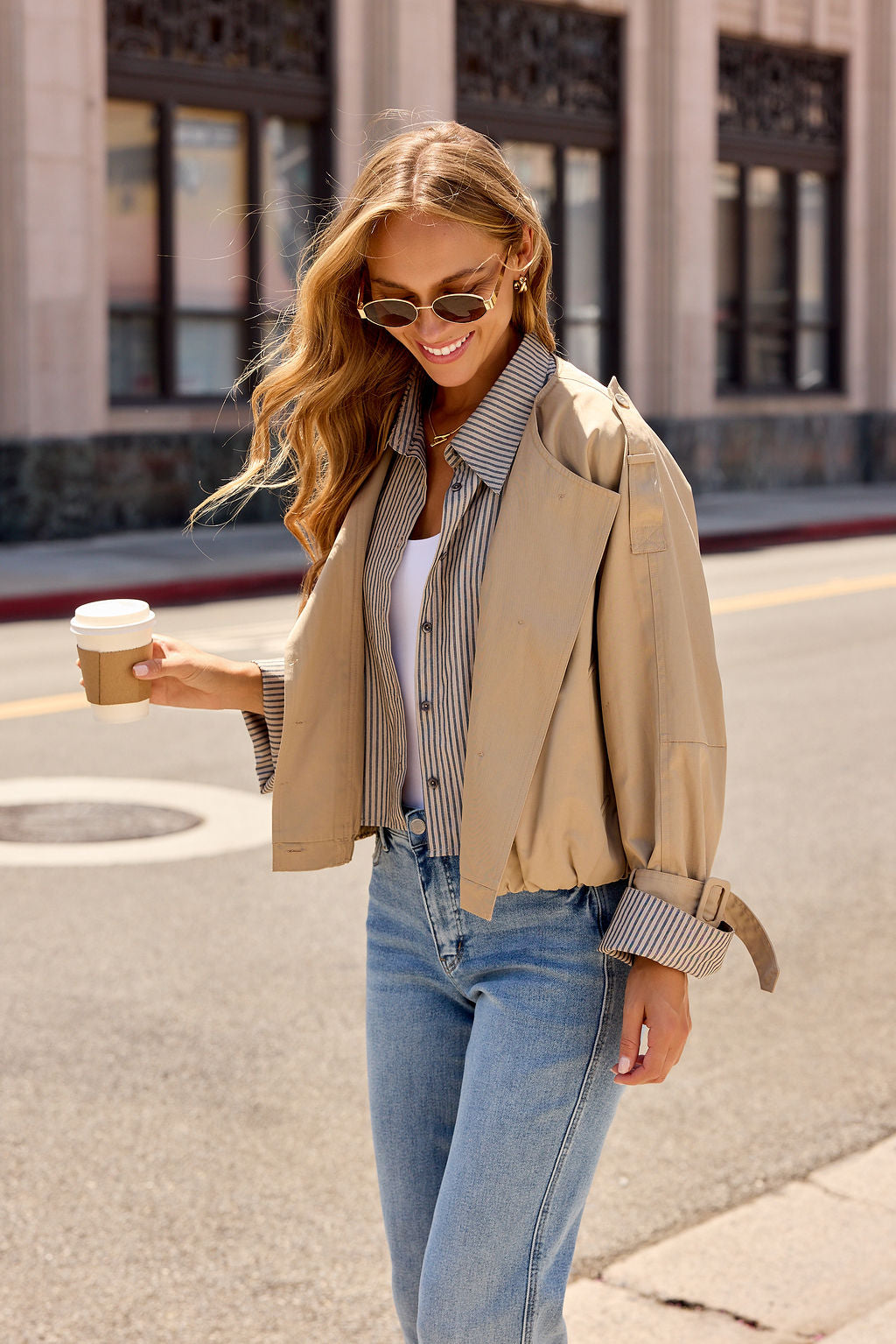 Smiling in the Contrast Striped Shirt Jacket - Camel, she strolls with coffee—a perfect transitional layer.