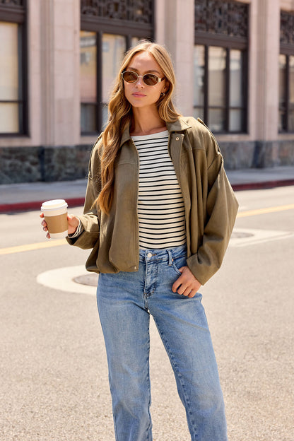 Woman in sunglasses holds coffee, wearing a Striped Shirt and Suede Bubble Hem Jacket - Olive—ideal for chic fall city layering.