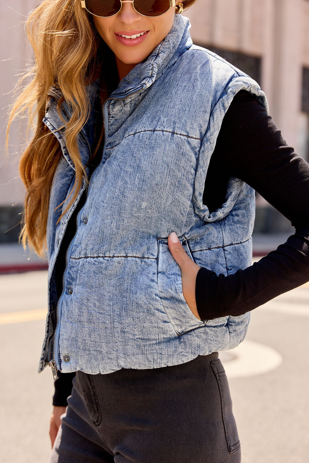 Smiling outdoors in the Vintage Havana Puffer Vest - Denim | Pre Order—ideal women’s fall outerwear for easy, stylish layering.