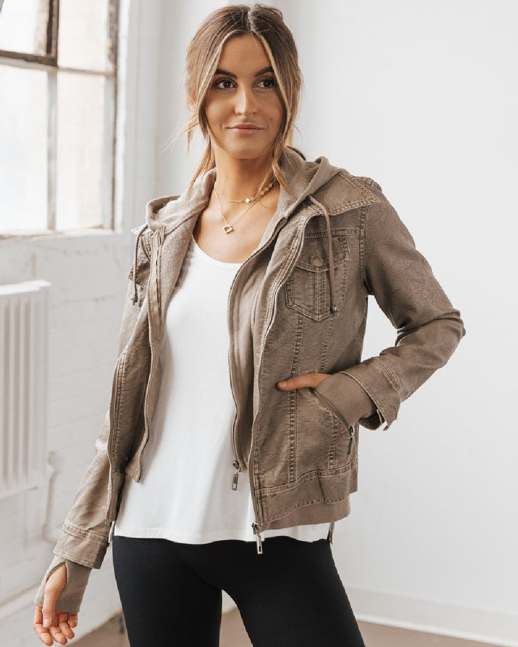 Mykal indoors in our Grey Hooded Sweatshirt Vegan Leather Jacket.