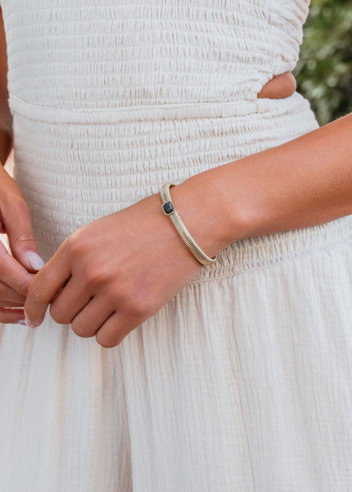 Close-up of a person wearing a bracelet on a blurred natural background