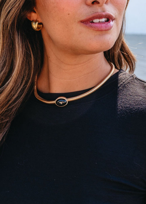Model is wearing our Gold_Snake_Chain_Black_Oval_Pendant_Necklace