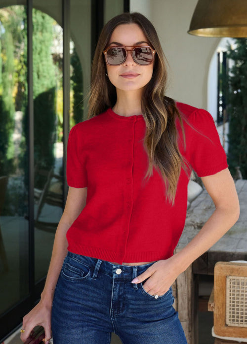 Savannah is standing outdoors wearing our Maura Red Short Sleeve Sweater Cardigan
