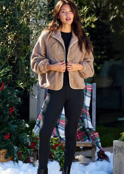 Gabbie is standing outdoors wearing our taupe-button-down-sherpa-jacket