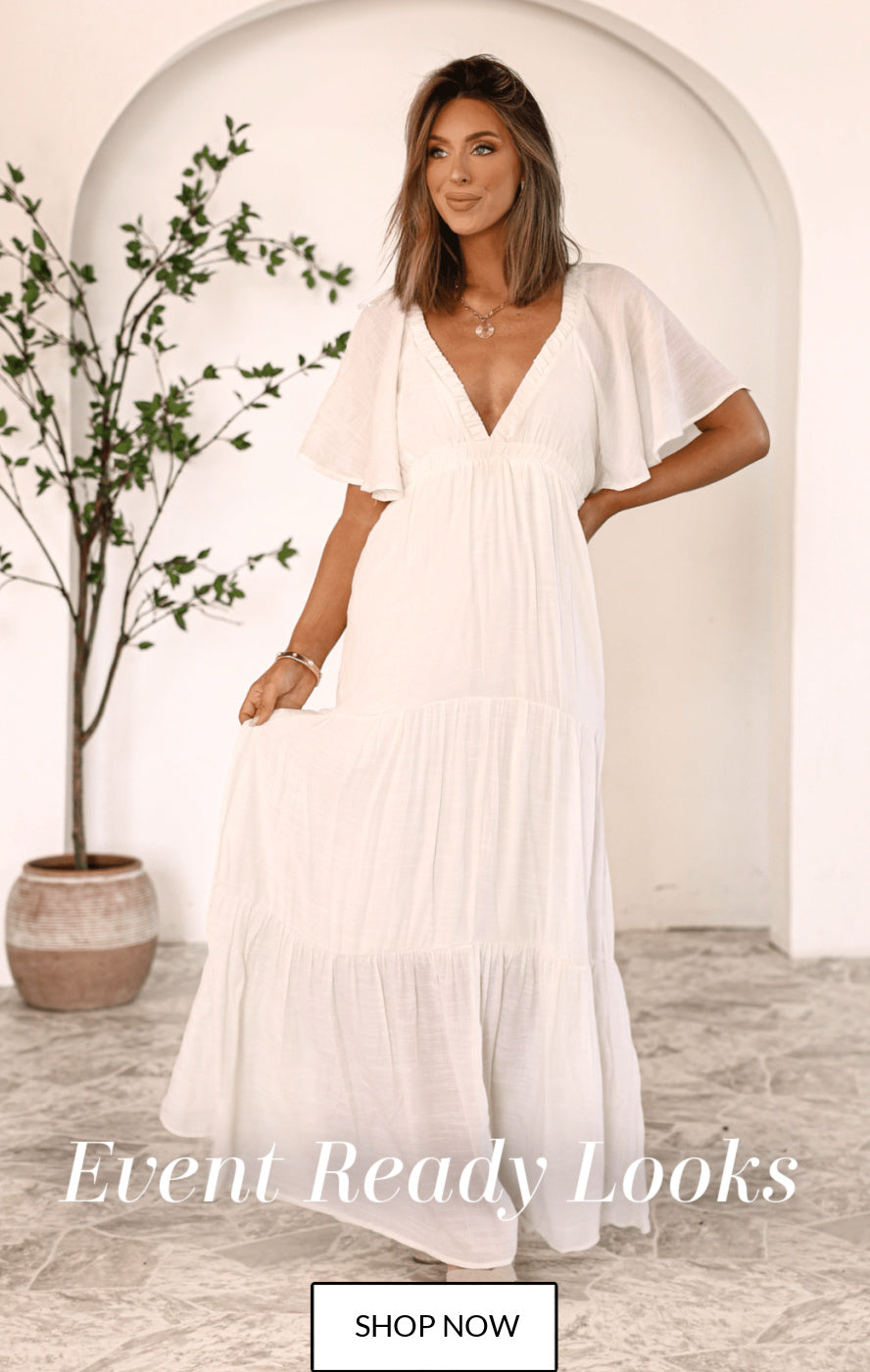 Home page hero image. Event Ready Looks, Shop Now text. Hayley A is wearing our our Ivory Whisper Tiered Maxi Dress.