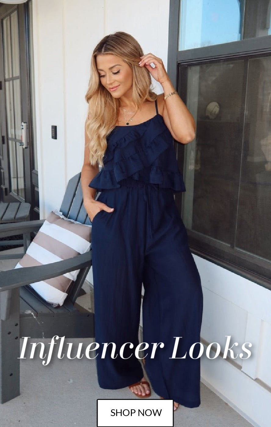 Woman wearing a navy blue ruffled jumpsuit on a porch with text 'Influencer Looks' and 'Shop Now'.