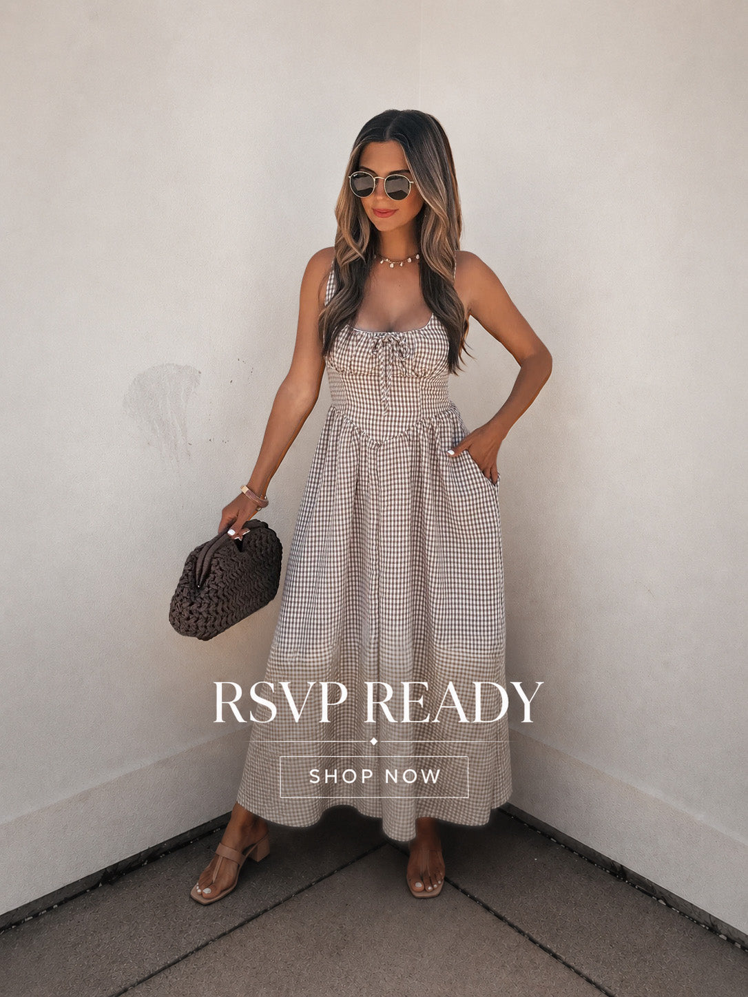 Woman in a checkered dress holding a woven handbag against a white wall with 'RSVP READY' text.