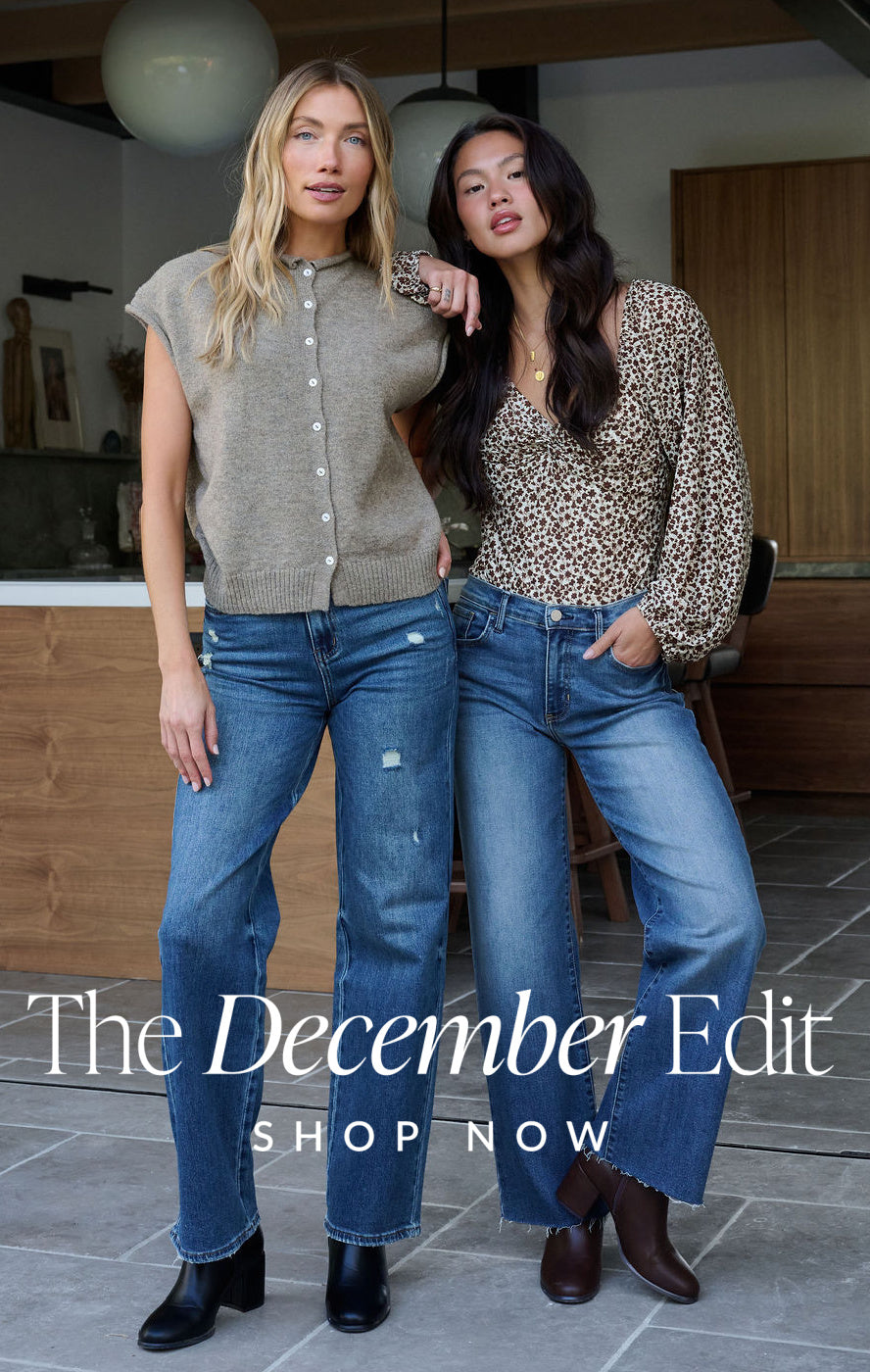 Two women posing together in jeans and button-up shirts with text 'The December Edit' and 'Shop Now'.