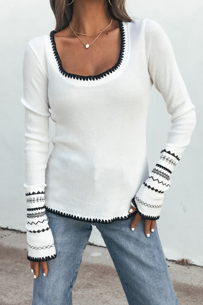 Woman wearing a Free People Aspen Thermal Top - White | Pre Order, featuring waffle knit, with light blue jeans.
