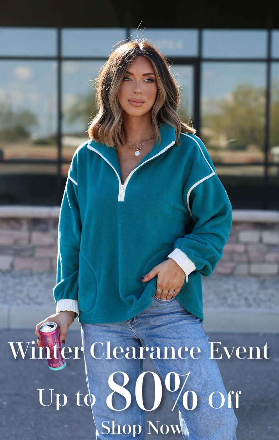 Woman wearing a teal jacket with a promotional text overlay for a winter clearance event.