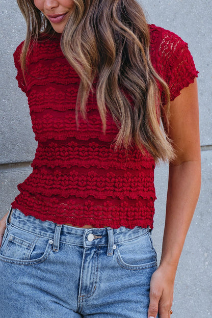 Woman wears the Amara Burgundy High Neck Lace Top with blue high-waisted jeans—perfect for your fall wardrobe.