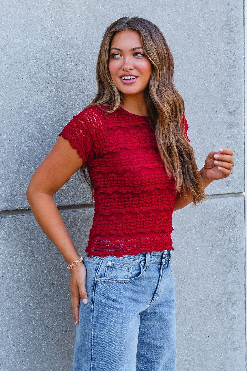 Woman with long brown hair wears the Amara Burgundy High Neck Lace Top—perfect for your fall wardrobe, FINAL SALE.