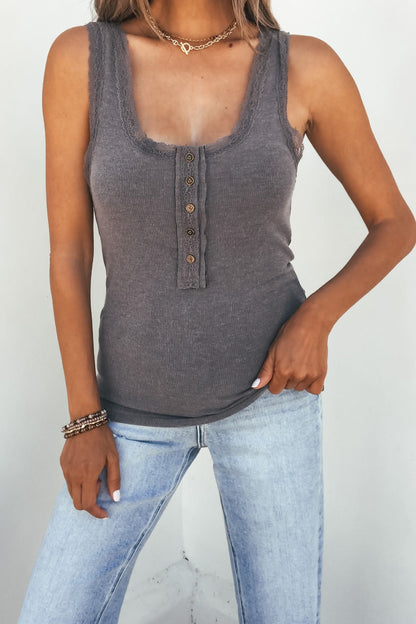 Woman wears the Ashlyn Lace Trim Button Tank – Grey with light blue jeans, standing against a plain white background.