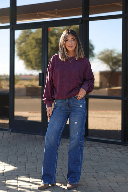 A woman with shoulder-length hair stands outdoors in maroon sweater and Bayeas Medium Wash Relaxed Straight Leg Jeans.