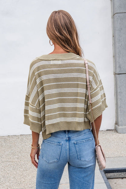 Woman with long hair in the Bellamy Striped Linen Sweater - Olive and jeans, holding a pink purse, back to camera.