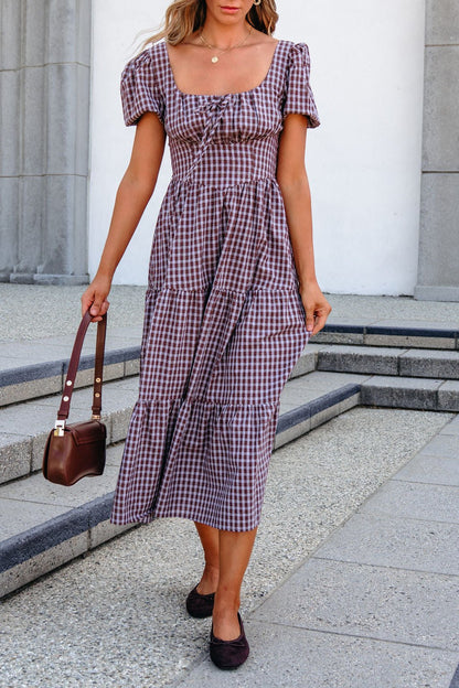 Woman in a mocha BLU PEPPER B6FD1108 midi dress holding a brown handbag, walking outdoors on stone steps.