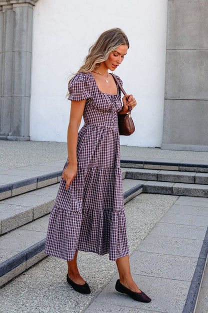 Woman in the BLU PEPPER B6FD1108 Mocha Midi Dress walks down steps with a brown shoulder bag and black flats.