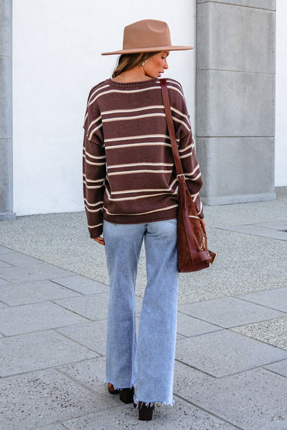 Individual wearing a tan hat and BLU PEPPER J6FT1014 BROWN STRIPED SWEATER stands with back to camera on city sidewalk.
