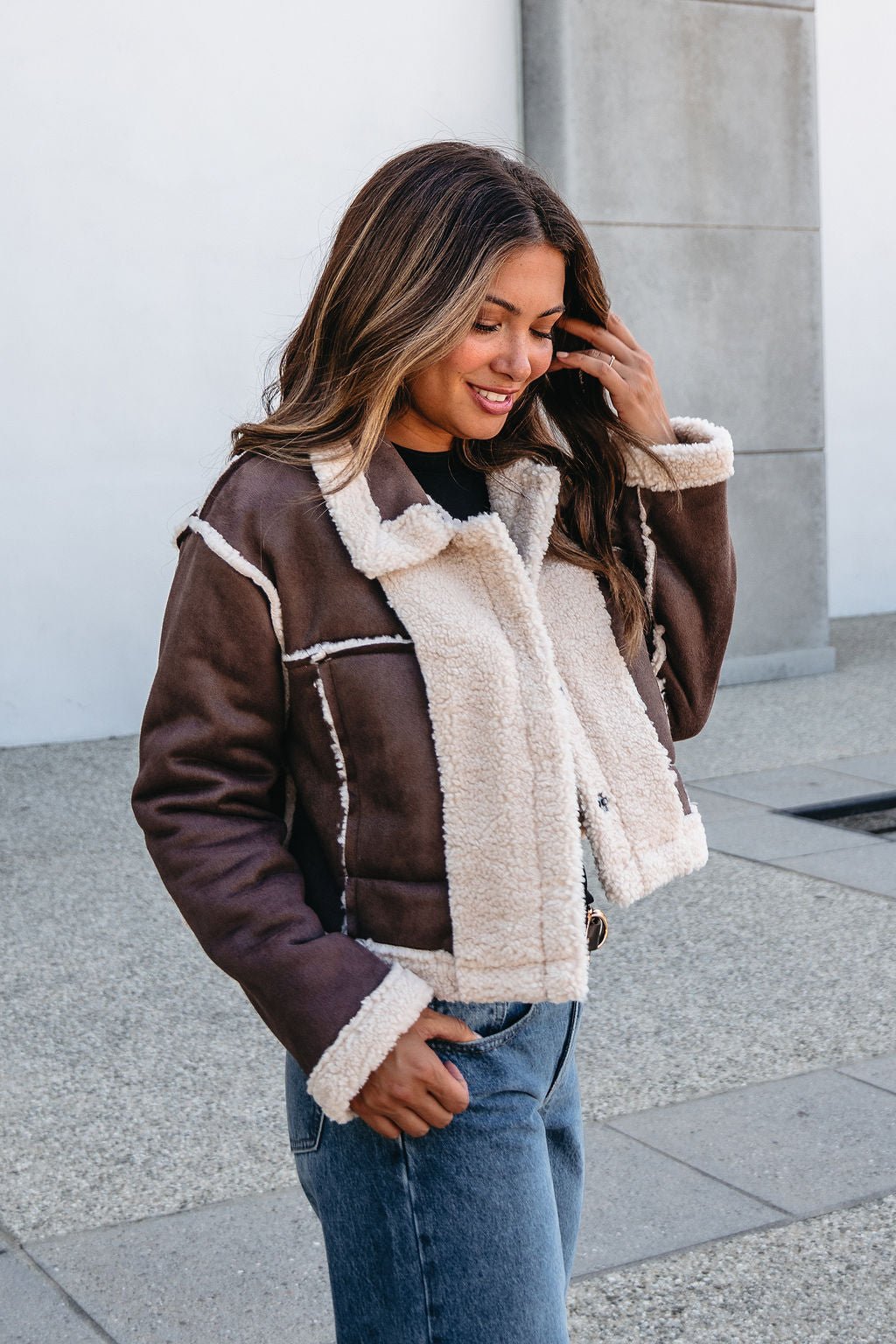 Smiling outdoors in the Brown Mix Reversible Suede Sherpa Jacket—an essential cold-weather layer for fall outfits.