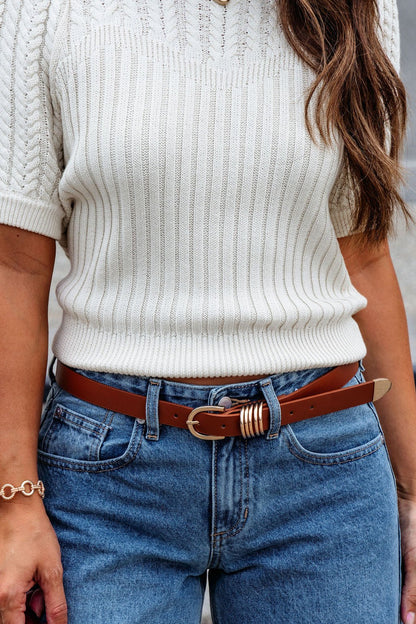 Woman outdoors in a white knit short-sleeve sweater, blue jeans, and a Brown Multi Ring Faux Leather Belt.