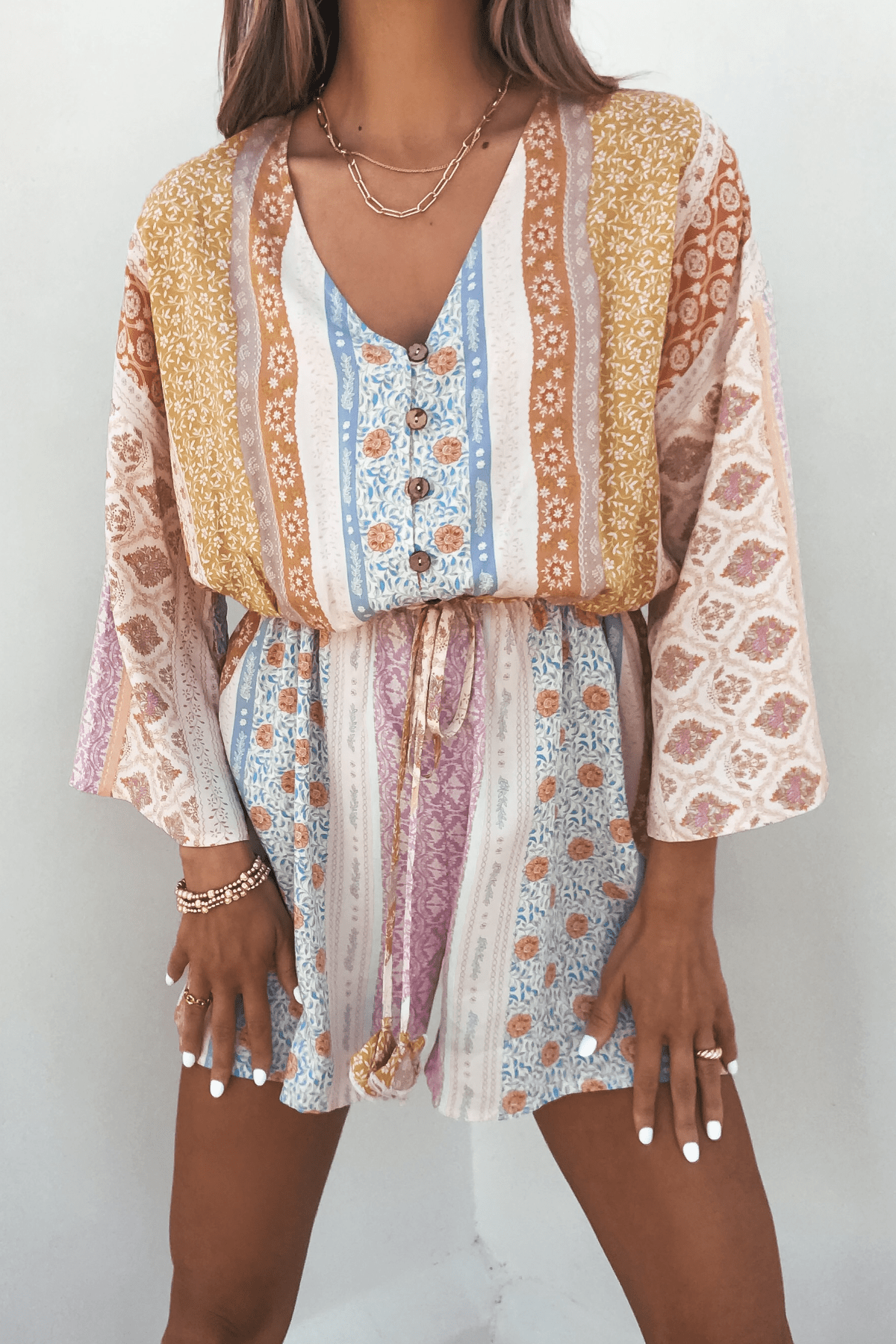 Callie's Painted Days Multi Print Romper—elastic waist, vibrant hues—makes a standout addition to your summer wardrobe.