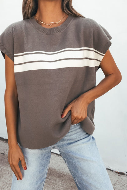 Woman in a relaxed fit Catalina Striped Top - Olive with white stripes, light blue jeans, and a simple necklace.