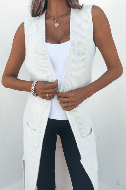 Woman in a Champagne Open Front Long Cardigan over a white top and black pants, accessorized with jewelry, on a white background.