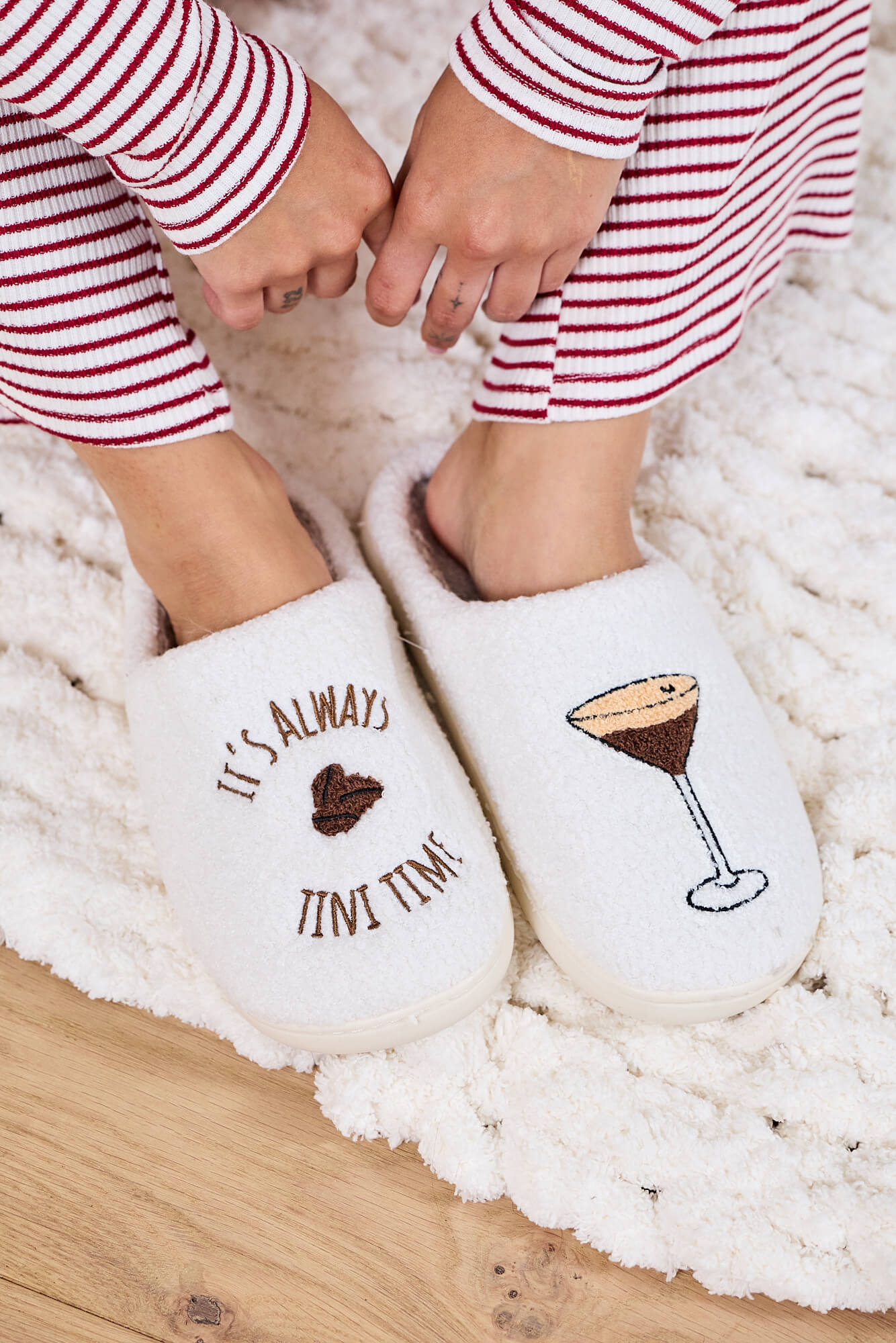 Wearing Cream Martini Plush Slippers-FINAL SALE, a cozy holiday gift with “It’s always tini time” embroidered on them.