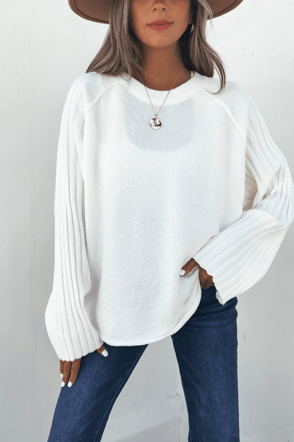 Woman in a wide-brim hat wears the Cream Raglan Sleeve Textured Sweater and blue jeans, standing against a white background.