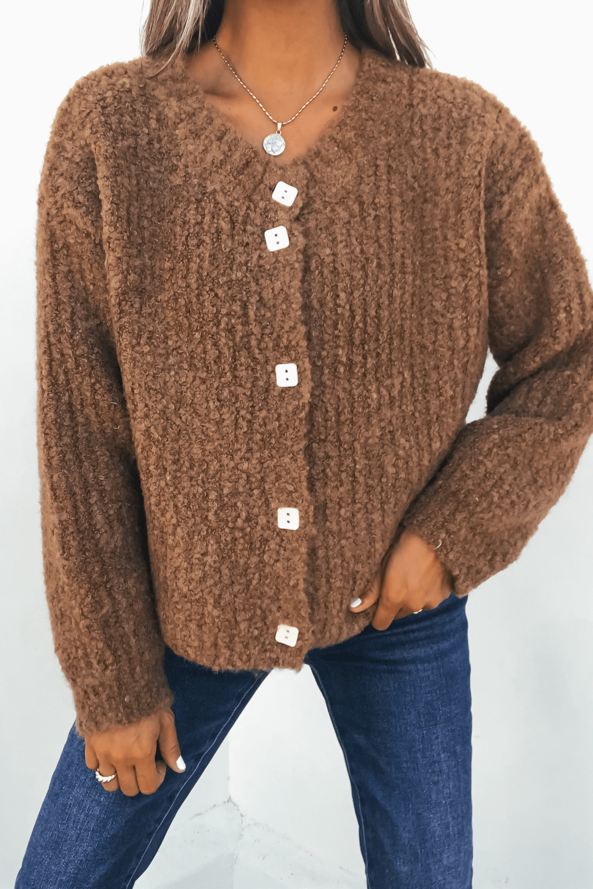 Woman wearing the Dark Amber Plush Button Down Cardigan - FINAL SALE with blue jeans, standing against a plain background.