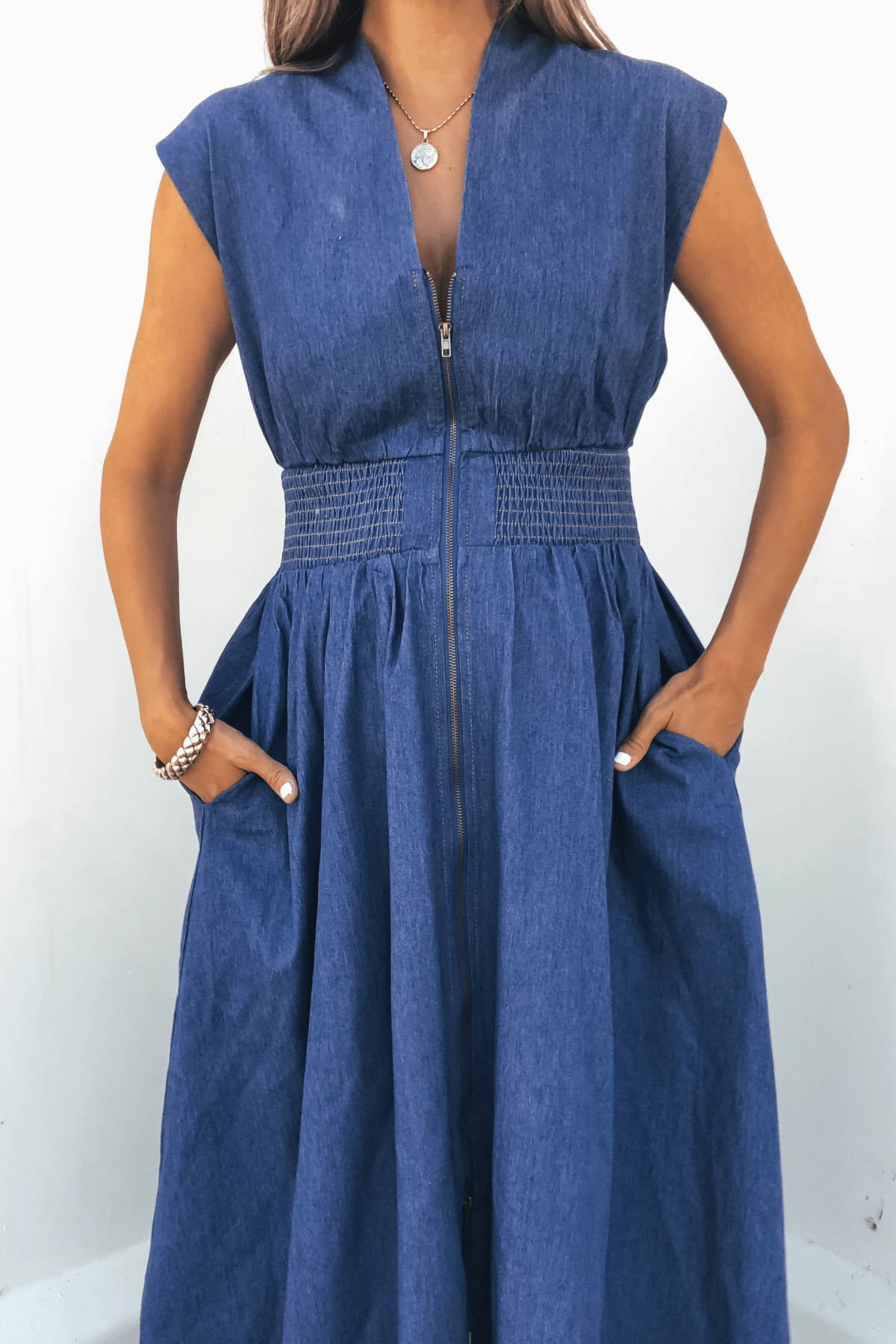 Person wearing the Denim Smocked Zip Up Midi Dress - FINAL SALE, standing against a light background.