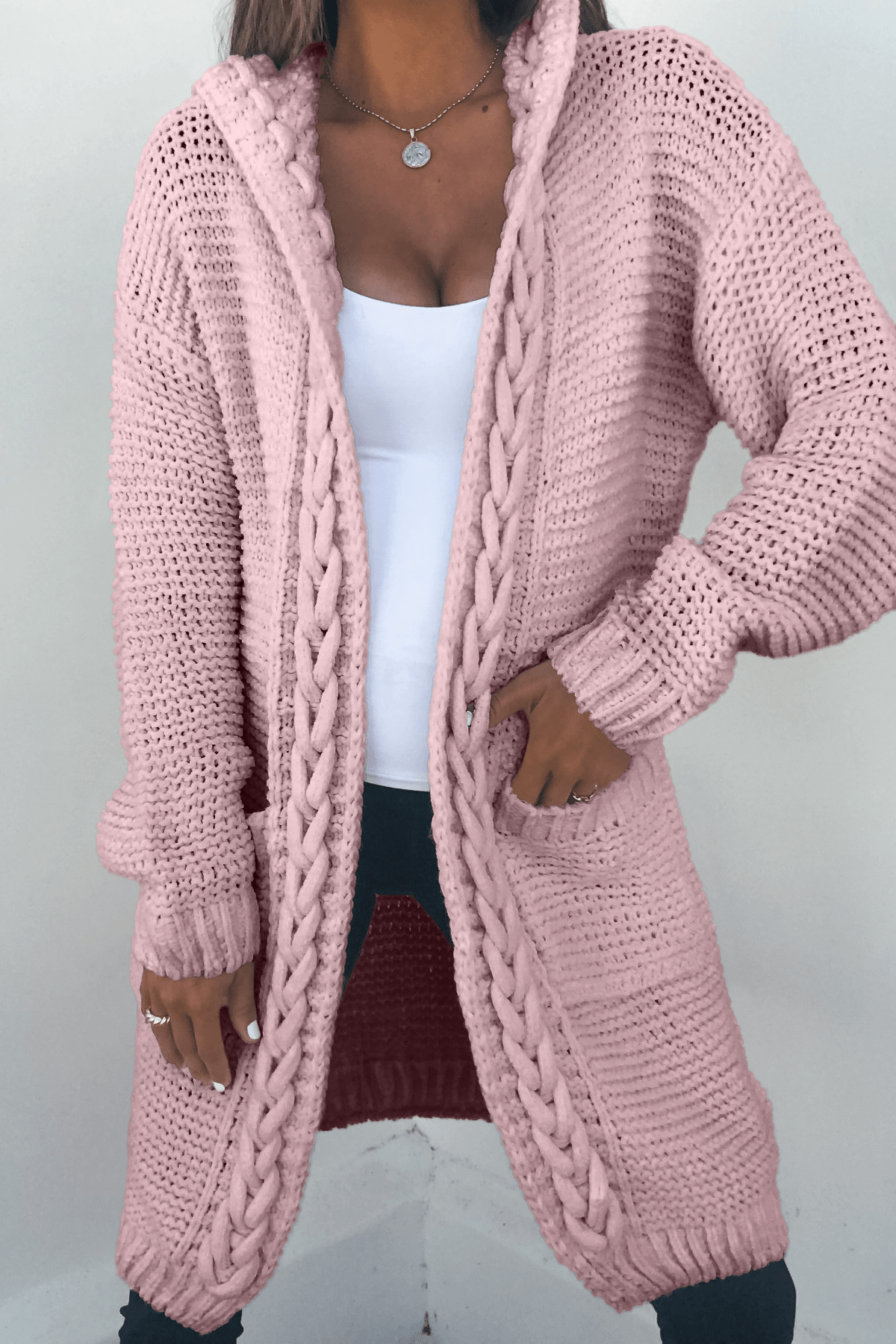 A woman wearing a Dusty Rose Braided Trim Hooded Cardigan.
