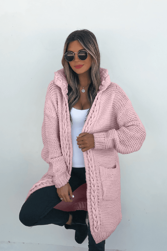 Woman wearing sunglasses, a Dusty Rose Braided Trim Hooded Cardigan, white top, and black pants poses against a plain white background.