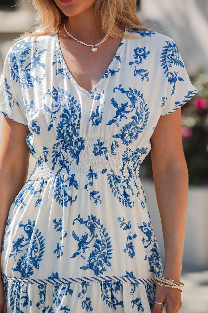 Woman in the Easton Blue Print Smock Tiered Midi Dress, styled with necklaces and bracelets.