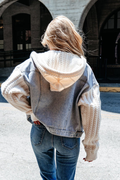 Blonde woman wears the Elan Denim Hooded Sweater Jacket, a perfect transitional layer, while standing outdoors.