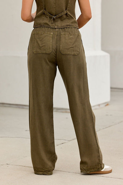 Individual in ELAN Elastic Drawstring Pants - Olive and matching top stands outdoors, back facing the camera.