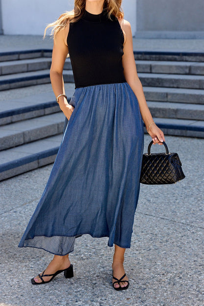 Woman outdoors in the Elan Two Tone Midi Dress - Navy, sandals, and a quilted black handbag.