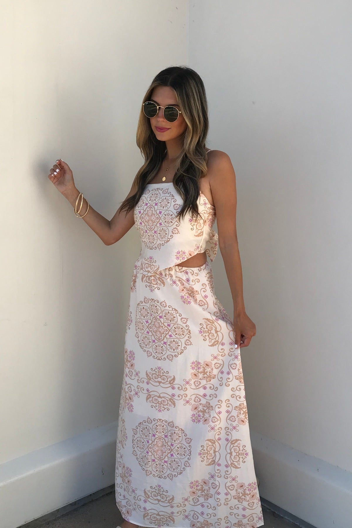 Woman in sunglasses wears the Evelyn Cream Print Tank Top, standing against a plain white wall.