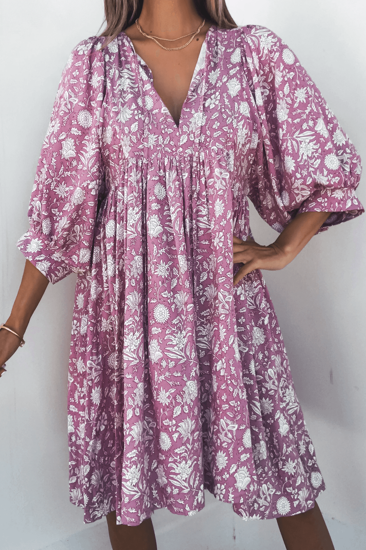 Woman wearing the Everly Pink Floral Print Mini Dress - FINAL SALE, featuring flowy half sleeves and a V-neckline.